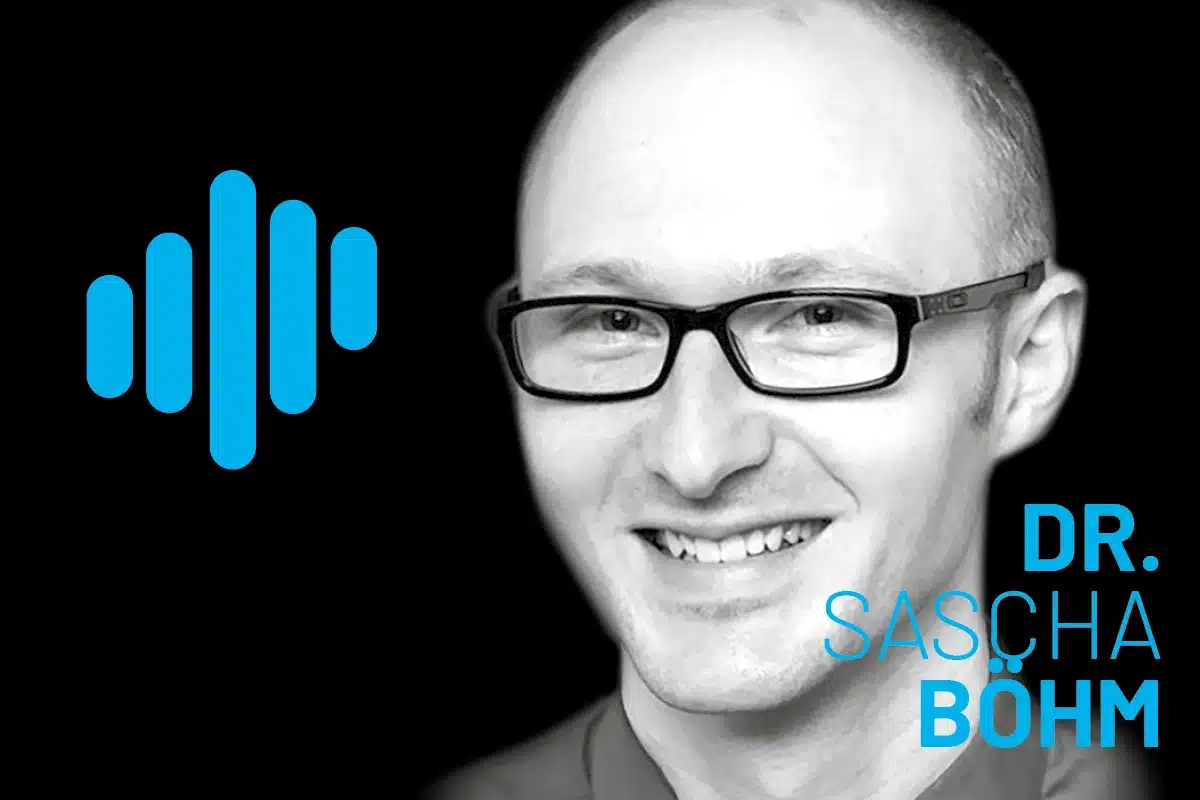 Sascha Böhm smiles in a high-contrast portrait with a black background, blue logo on the left, and bold blue 'DR. SASCHA BÖHM' typography on the right.