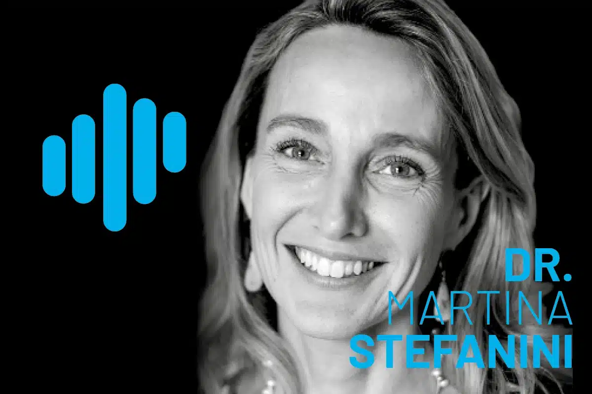 Portrait of Dr. Martina Stefanini in grayscale against a black background, with a blue waveform logo to the left and bold blue typography displaying her name.
