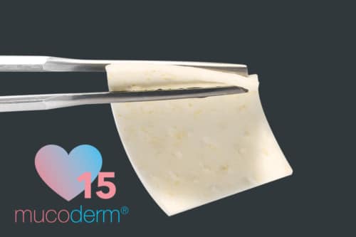 Mucoderm® 15 material being held with surgical tweezers, showcasing its texture and appearance.