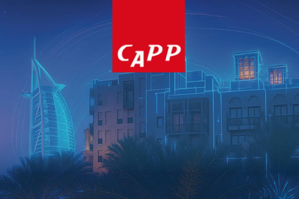 Blue urban cityscape at night with modern glass buildings, palm fronds in foreground, and a bold red CAPP banner overhead, creating a cool-lit skyline