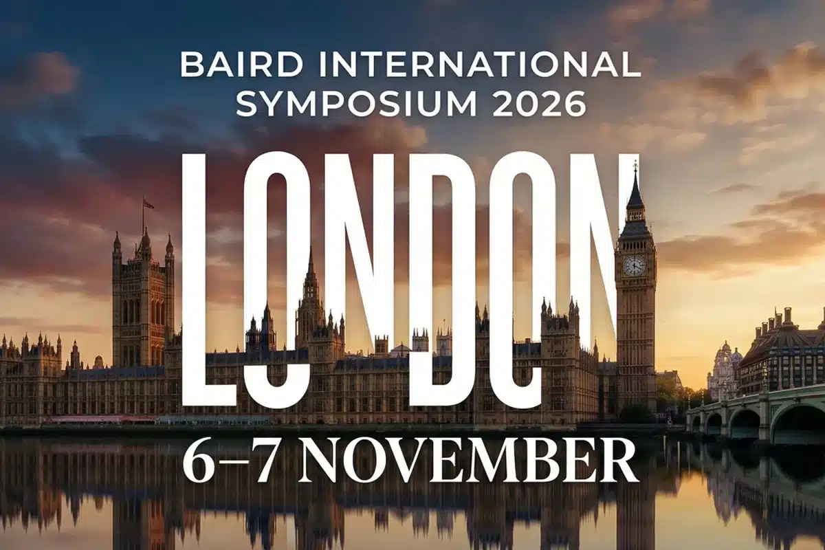 BAIRD International Symposium 2026 a London, 6–7 November. Grande testo bianco su skyline con riflessi al tramonto e atmosfera densa di città.