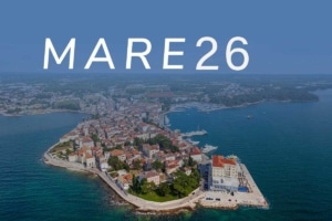 Mare 2026 over the Croatian coast in Poreč, with an aerial view of a harbor and blue sea beneath the “MARE 26” lettering.